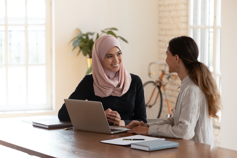 two women from diverse backgrounds chatting