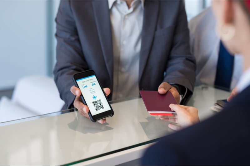 man showing passport at airport booth