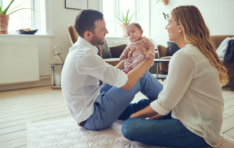 mum and dad holding a baby