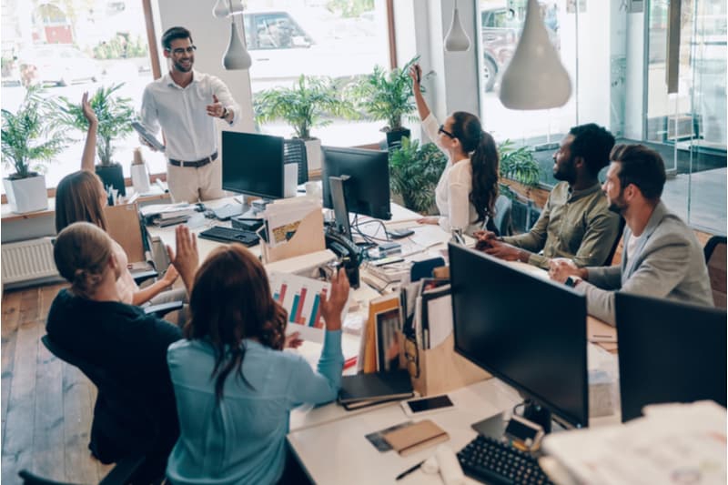 working having a meeting with show of hands