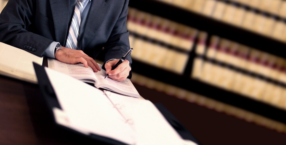 lawyer signing a settlement agreement