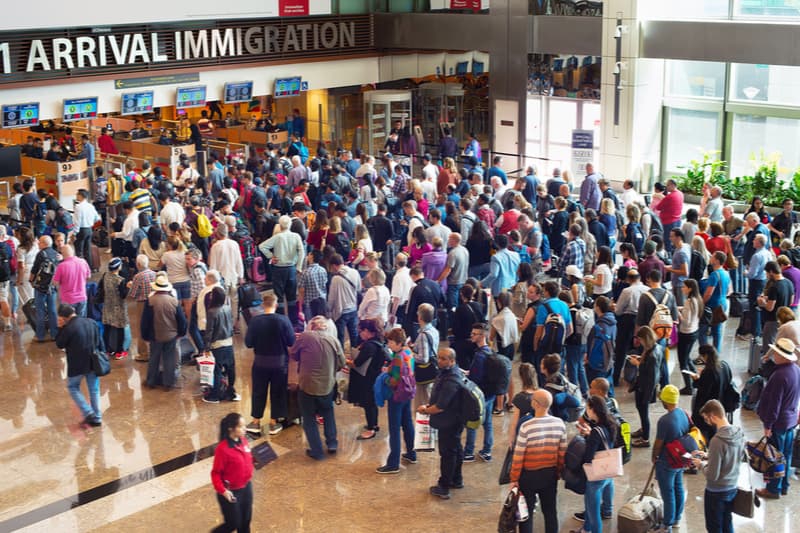 crowds of people at airport immigration gate
