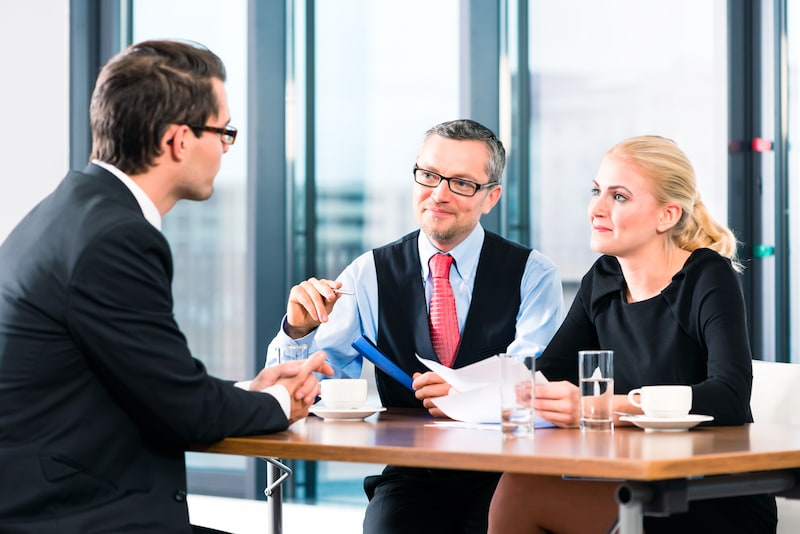 commercial lawyer giving advice to a couple