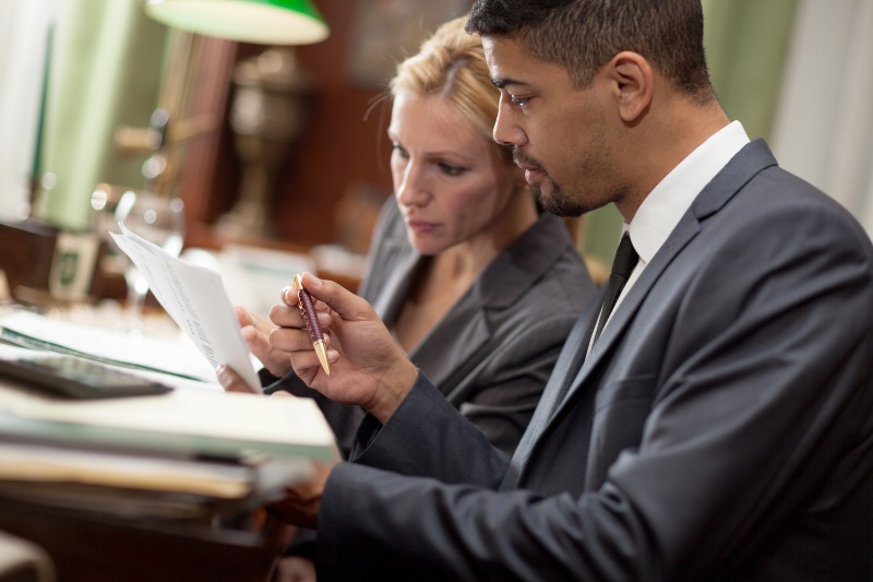Two lawyers discussing a document