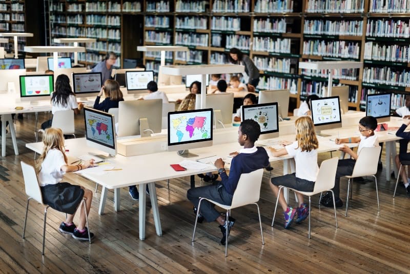 primary school children sitting at desks