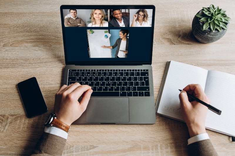 businessman with a laptop taking notes