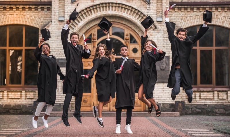 university students graduating wearing gowns